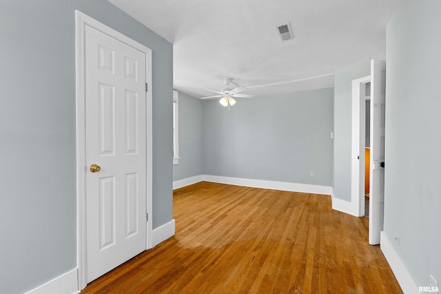 empty room with light wood-type flooring and ceiling fan