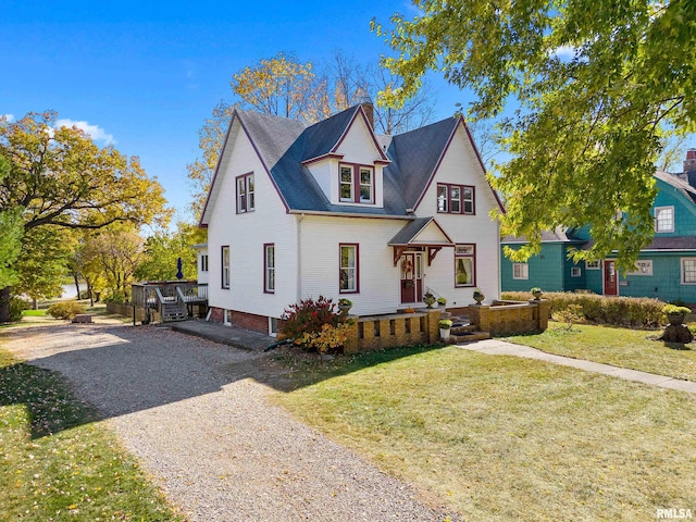 view of front of home featuring a front yard and a wooden deck