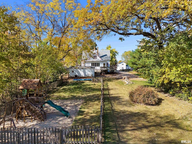 exterior space featuring a lawn and a playground