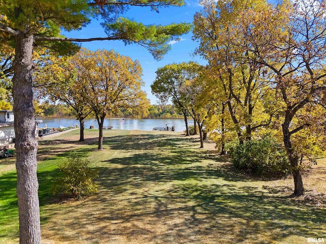 view of home's community featuring a water view and a yard