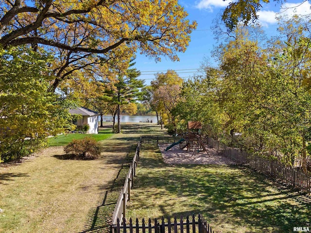 view of yard with a water view and a playground