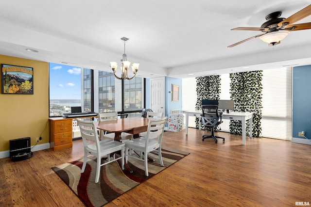 dining area featuring hardwood / wood-style flooring, plenty of natural light, and ceiling fan with notable chandelier