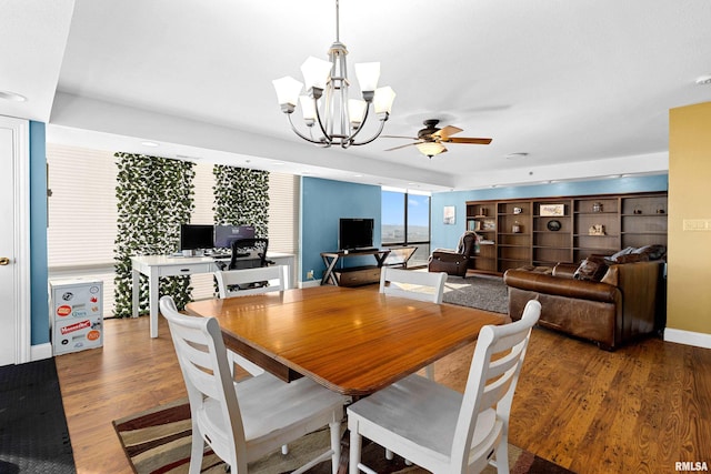 dining room featuring dark hardwood / wood-style floors and ceiling fan with notable chandelier