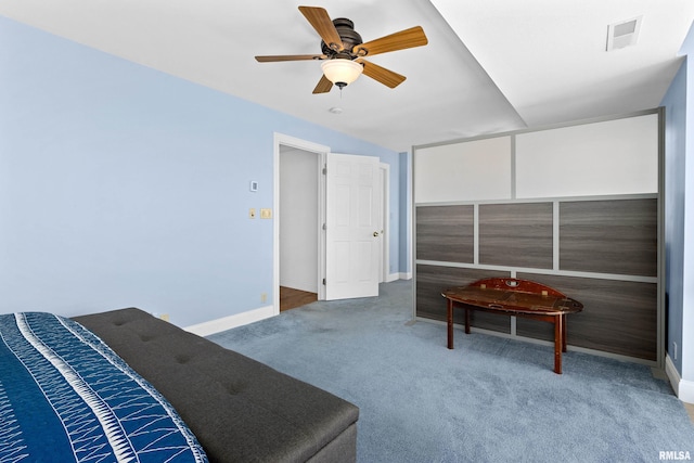 living area featuring ceiling fan and carpet