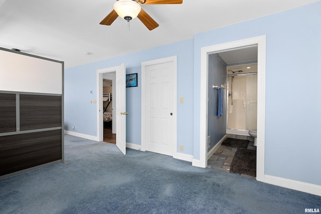 unfurnished bedroom with dark colored carpet, ensuite bathroom, and ceiling fan