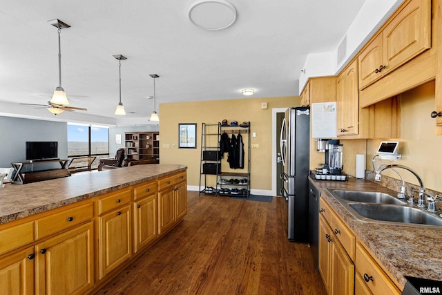 kitchen with dark hardwood / wood-style floors, sink, pendant lighting, stainless steel refrigerator, and ceiling fan