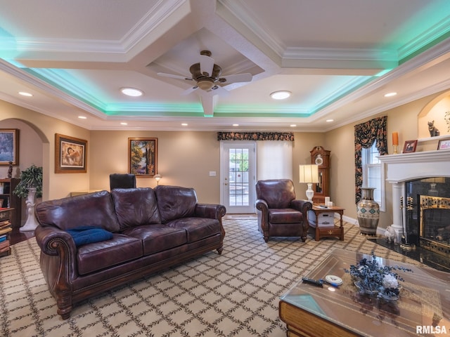 carpeted living room featuring a fireplace, beam ceiling, ornamental molding, and coffered ceiling