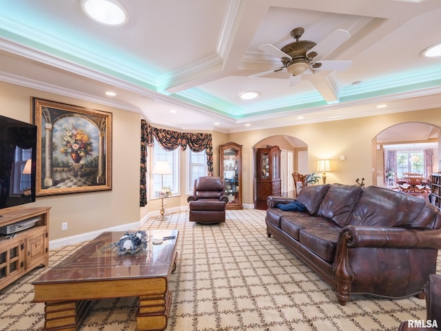 living room with crown molding, ceiling fan, a healthy amount of sunlight, and coffered ceiling