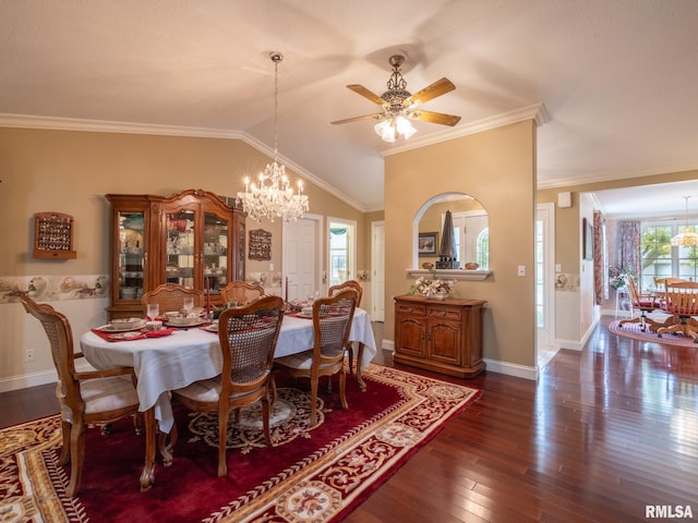 dining space featuring lofted ceiling, ceiling fan with notable chandelier, dark hardwood / wood-style floors, and ornamental molding