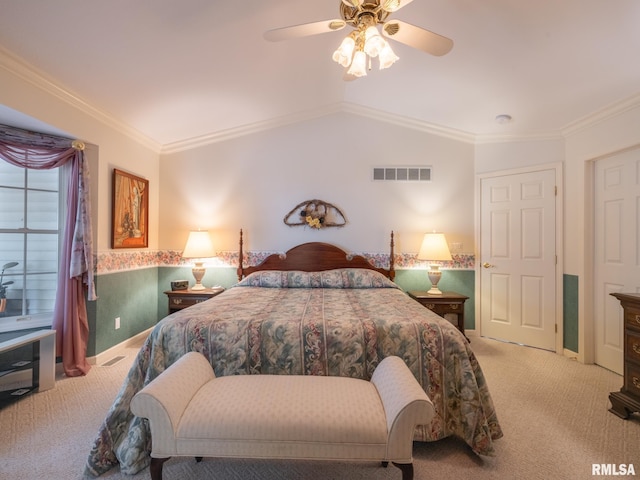 bedroom with ceiling fan, crown molding, light colored carpet, and vaulted ceiling