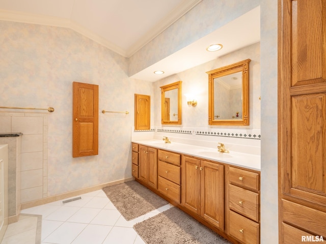 bathroom with tile patterned flooring, vanity, crown molding, and vaulted ceiling