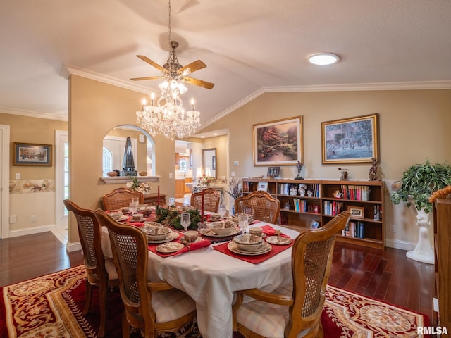 dining room with ceiling fan, dark wood-type flooring, vaulted ceiling, and ornamental molding