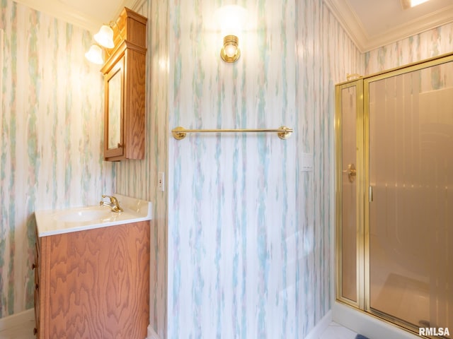 bathroom featuring vanity, crown molding, and walk in shower