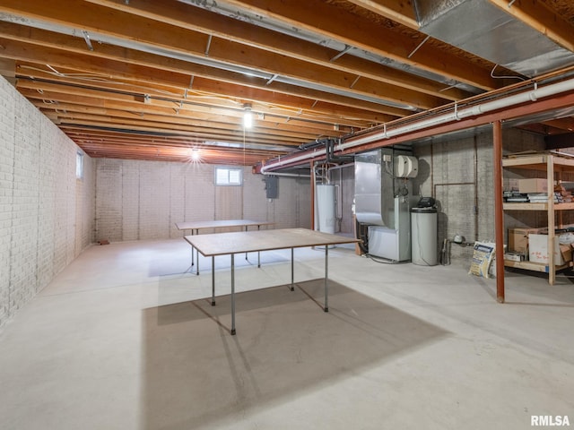 basement with water heater and brick wall