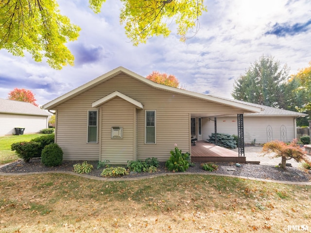 view of front of house with a wooden deck and a front yard