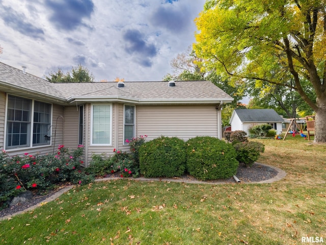 view of side of home with a lawn