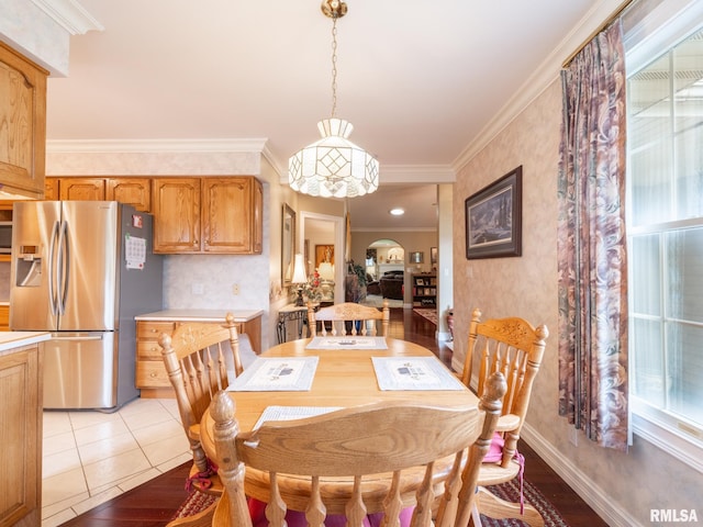 dining room with light hardwood / wood-style floors and ornamental molding