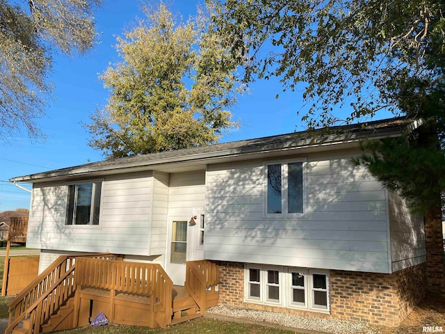 rear view of property featuring a deck