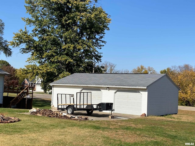 rear view of house with a lawn and a garage