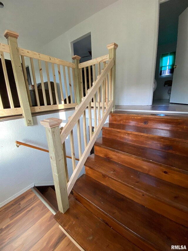 stairway featuring hardwood / wood-style floors