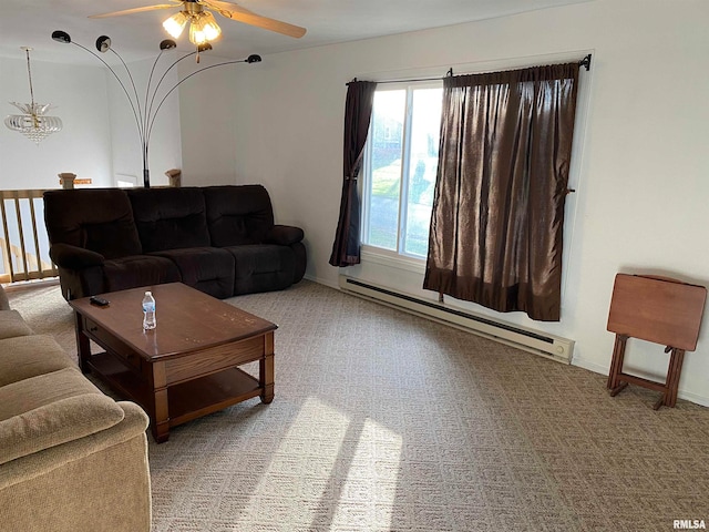 carpeted living room featuring ceiling fan with notable chandelier and a baseboard radiator