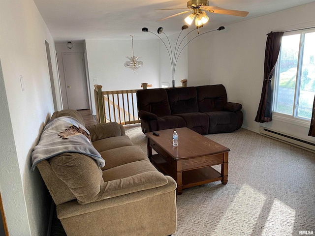 carpeted living room with ceiling fan with notable chandelier and a baseboard heating unit