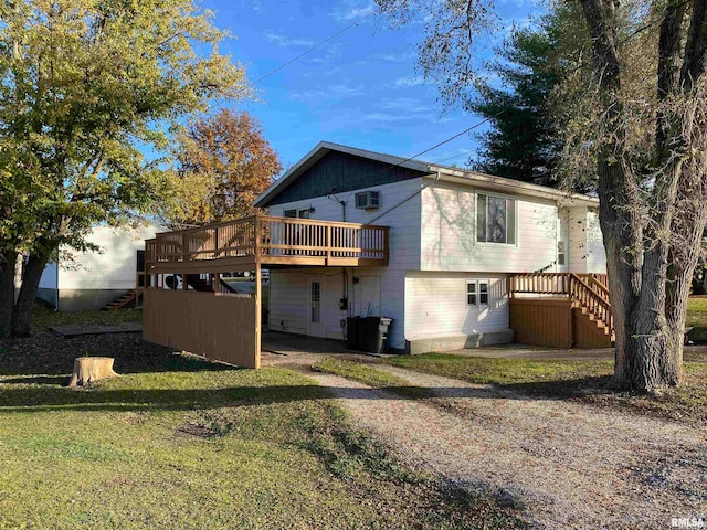 rear view of house with a yard, central AC, and a wooden deck