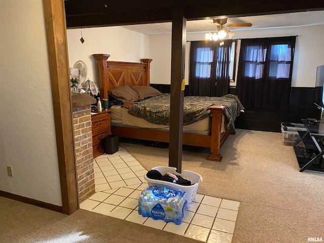 bedroom featuring light carpet, beamed ceiling, and ceiling fan