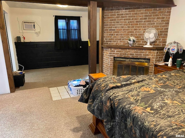 bedroom featuring carpet floors, a fireplace, and an AC wall unit