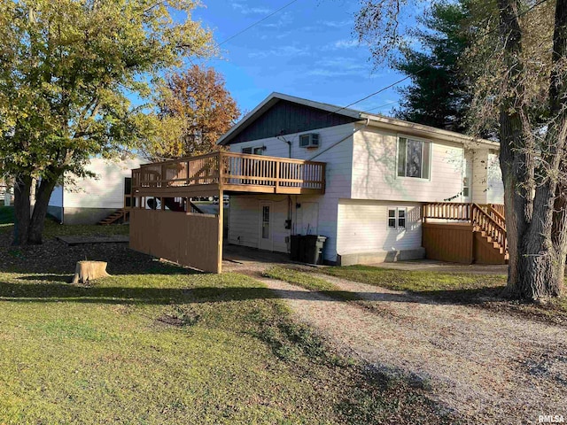 back of property featuring a yard and a wooden deck