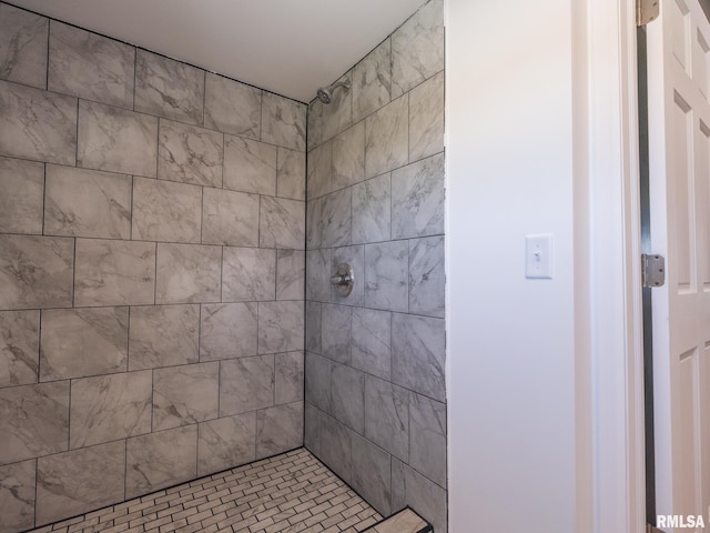 bathroom with a tile shower