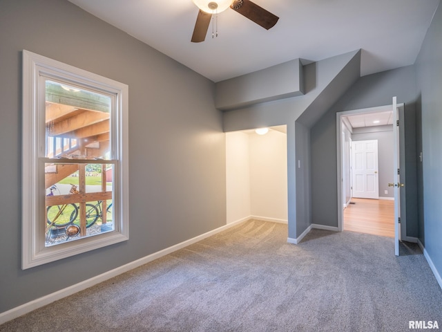 carpeted empty room featuring ceiling fan