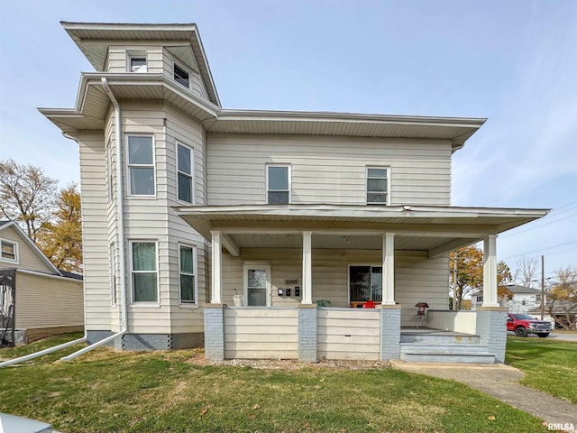 view of front of home with covered porch and a front yard