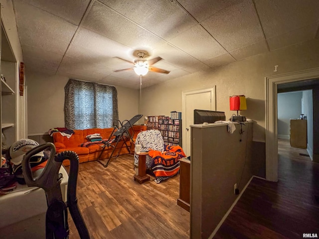 playroom featuring a paneled ceiling, wood-type flooring, and ceiling fan