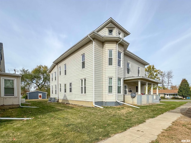 view of property exterior with a lawn and cooling unit