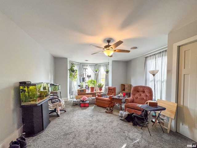 living area featuring ceiling fan and carpet floors