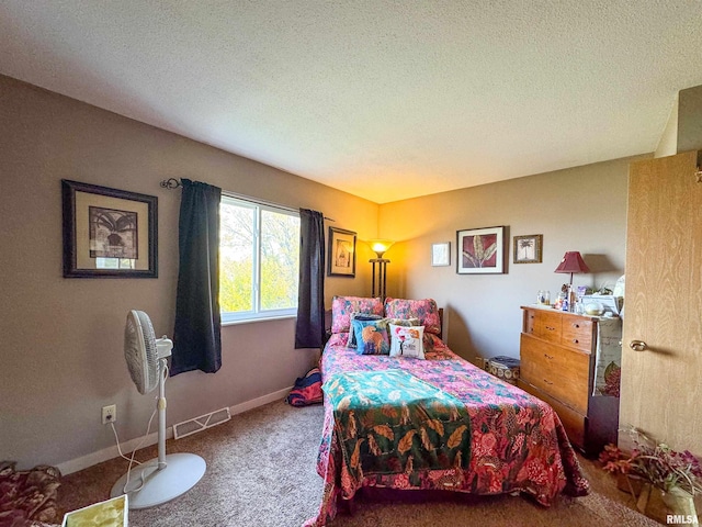 bedroom with carpet and a textured ceiling