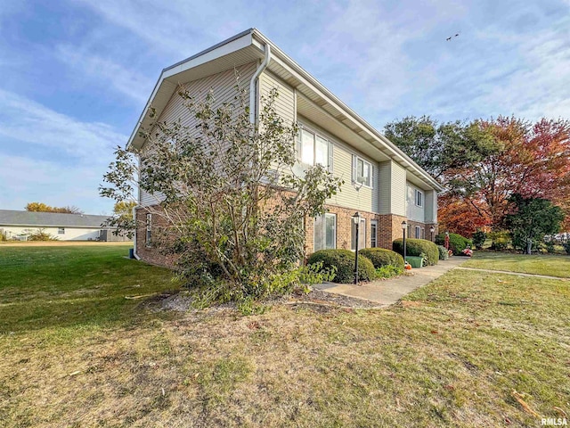 view of side of property with a yard