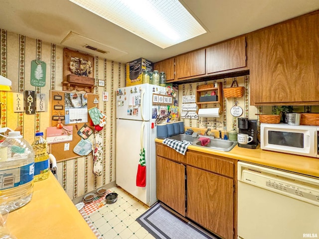 kitchen with white appliances and sink