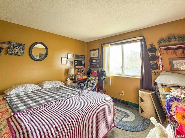 bedroom featuring carpet floors and a textured ceiling