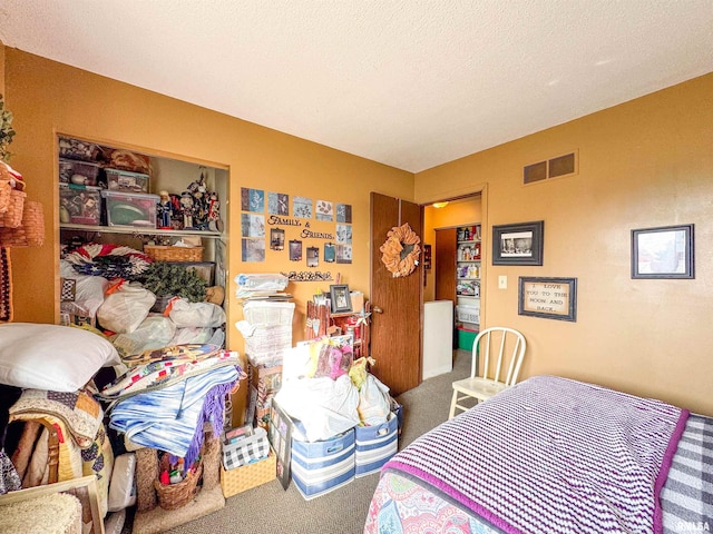 carpeted bedroom featuring a textured ceiling