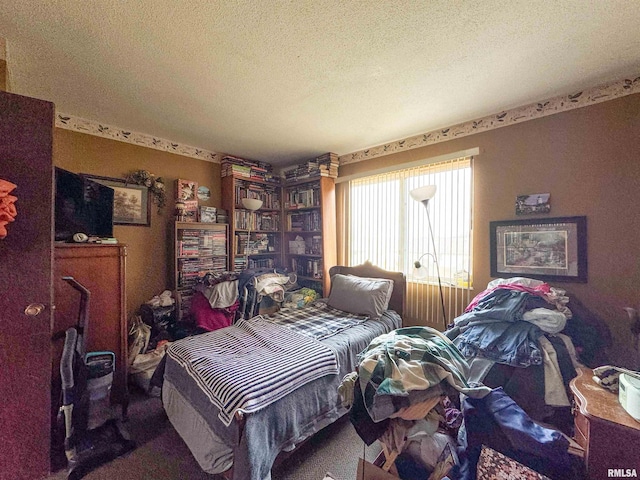 carpeted bedroom featuring a textured ceiling