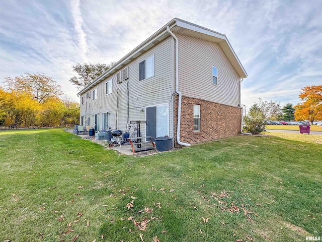 view of property exterior with a lawn and a patio