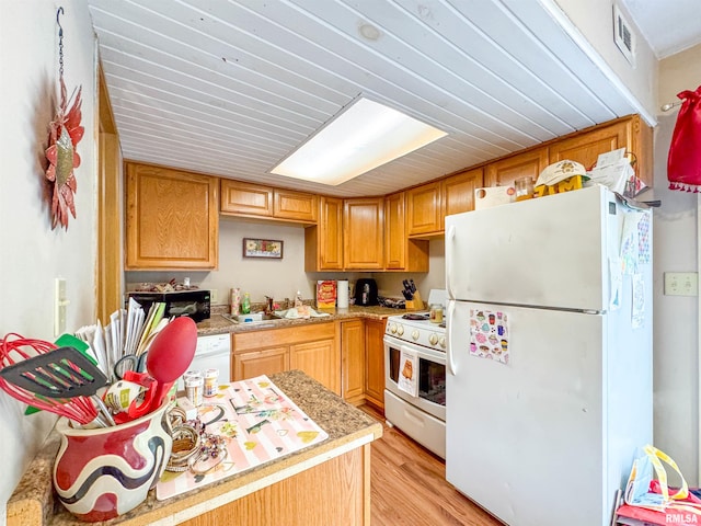 kitchen featuring light hardwood / wood-style floors, white appliances, and sink