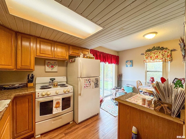 kitchen with light hardwood / wood-style flooring and white appliances