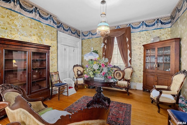 living area featuring hardwood / wood-style floors and an inviting chandelier