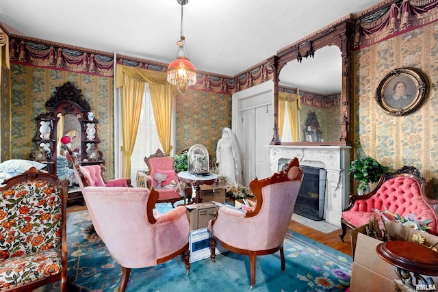 living area featuring hardwood / wood-style floors and a chandelier