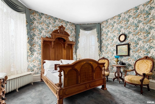 carpeted bedroom featuring radiator