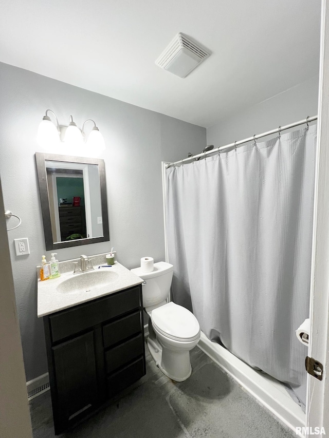 bathroom with vanity, a shower with shower curtain, and toilet