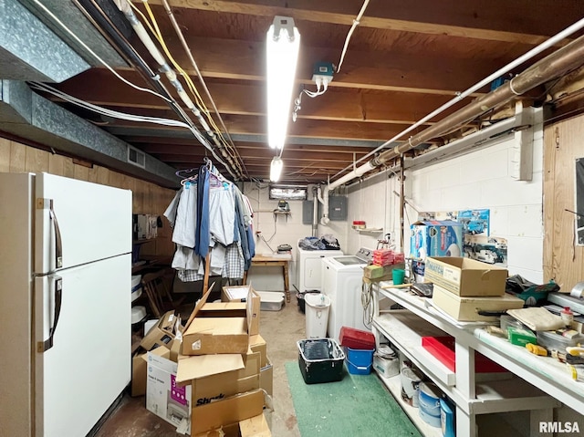 basement with white refrigerator and washing machine and dryer